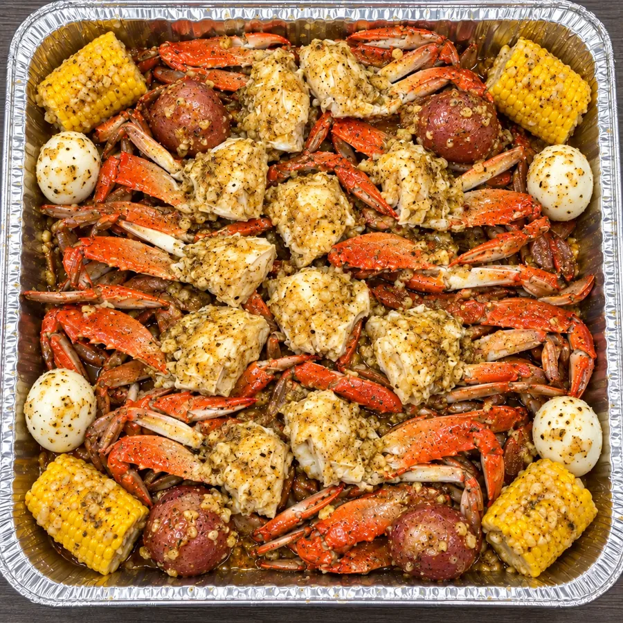 The Blue Takeover with 12 steamed blue crabs broken into 24 halves in a large aluminum tray