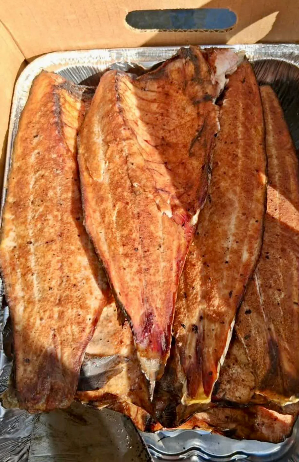 Droopy D’s seasoned smoked mullet in an aluminum tray